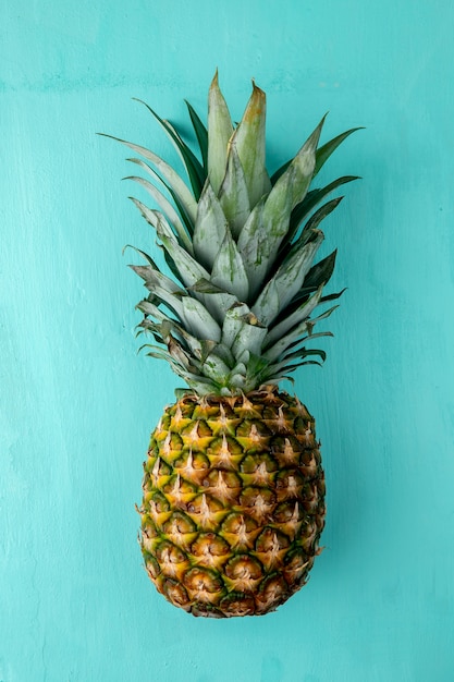 Top view of pineapple on blue surface