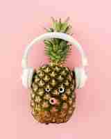 Free photo top view pineapple with headphones