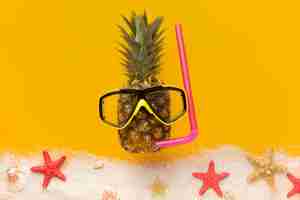 Free photo top view pineapple with summer accessories