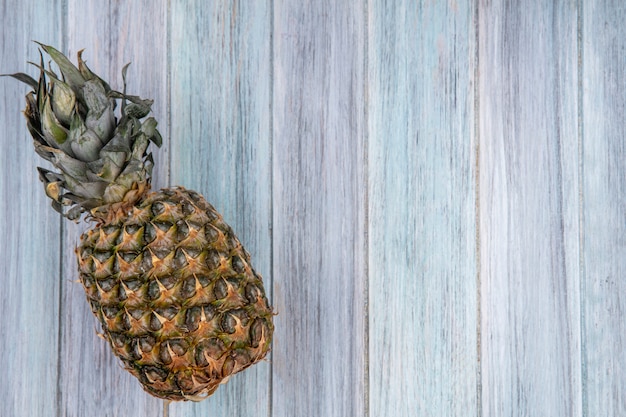 Top view of pineapple on wooden surface