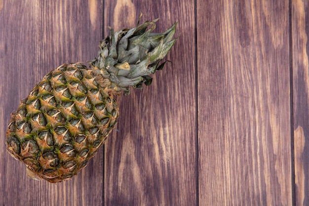 Top view of pineapple on wooden surface