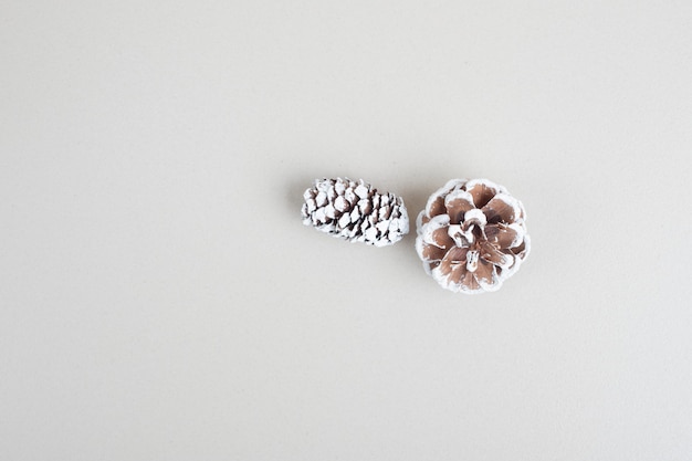 Top view of pinecones on beige surface