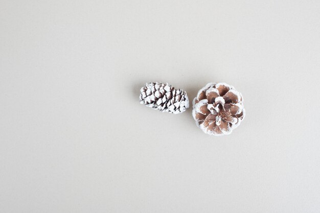 Top view of pinecones on beige surface