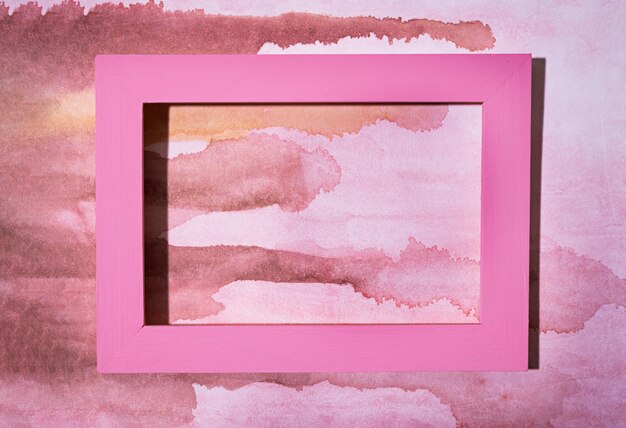 Top view pink frame on hand painted background