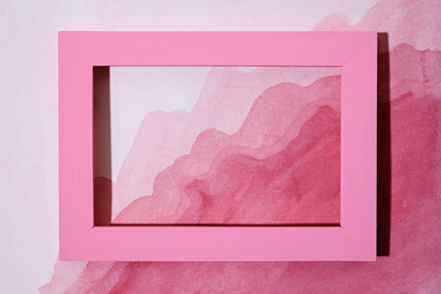 Top view pink frame on hand painted background