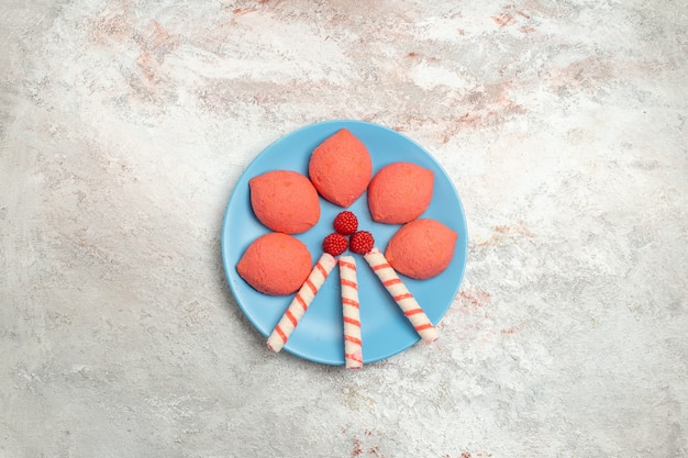 Top view pink gingerbreads inside plate on white background cake biscuit sweet pie sugar cookies