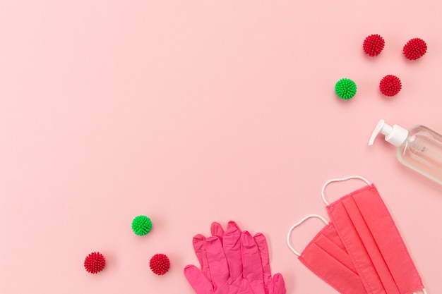 Free photo top view pink medical masks and gloves with blank phone and copy-space