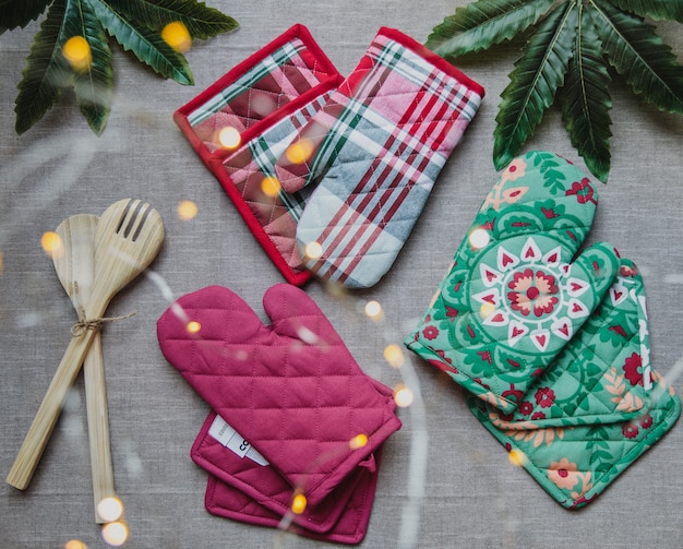 Free photo top view of pink and patterned protective oven gloves and potholders on grey surface