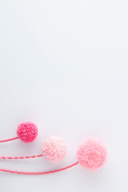 Top view pink pom poms with copy space