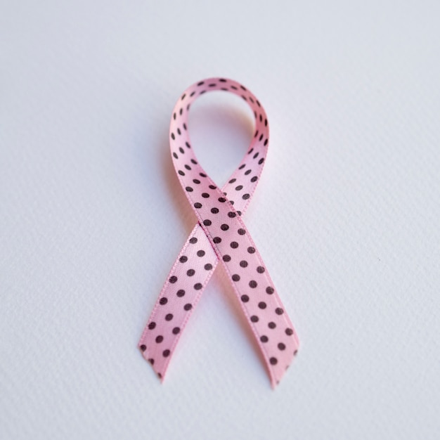 Free photo top view pink ribbon with black dots