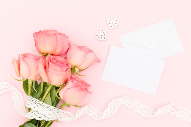 Top view of pink roses with envelope