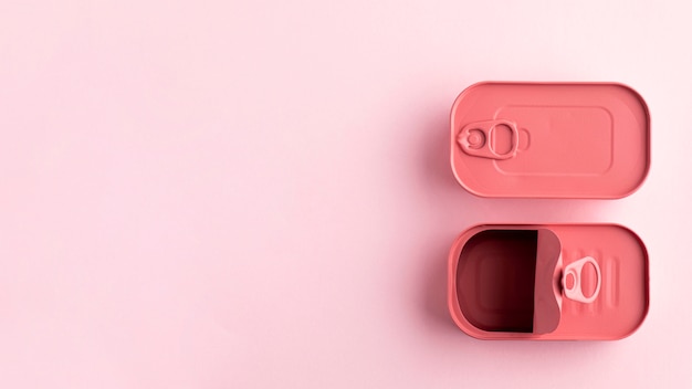 Top view pink rounded rectangle tin cans with copy-space