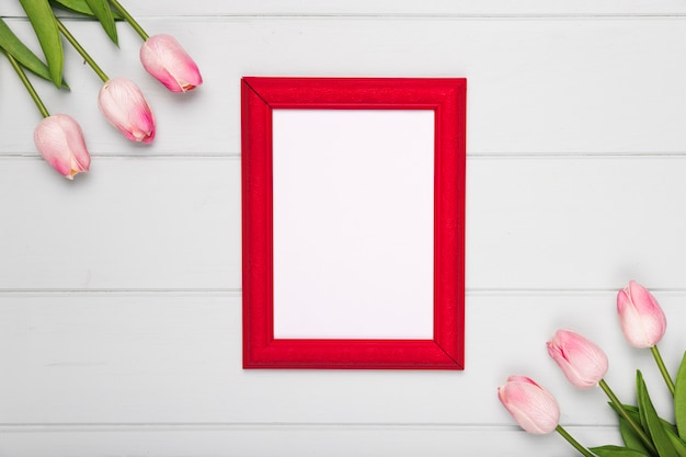 Free photo top view pink tulips beside frame