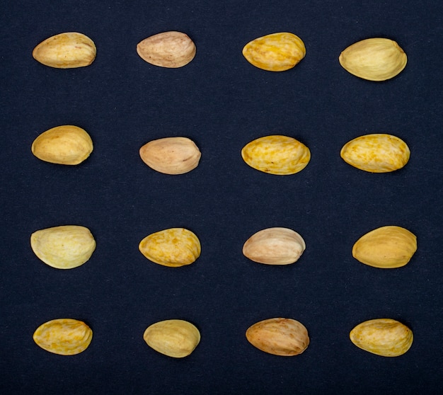 Top view of pistachio nuts isolated on a black background