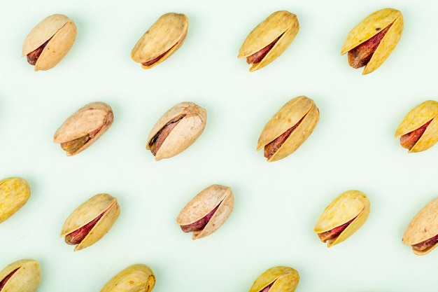 Free photo top view of pistachio nuts isolated on a white background