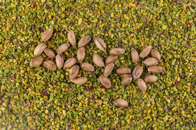 Top view pistachios on crushed or granulated texture 