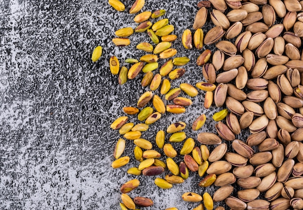 Top view pistachios with copy space on gray texture  horizontal