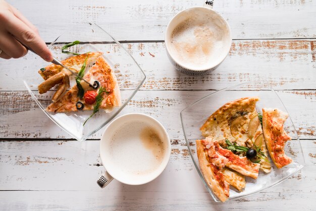 Top view pizza and coffee on white table