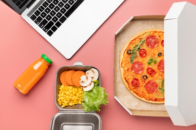 Free photo top view pizza and laptop arrangement