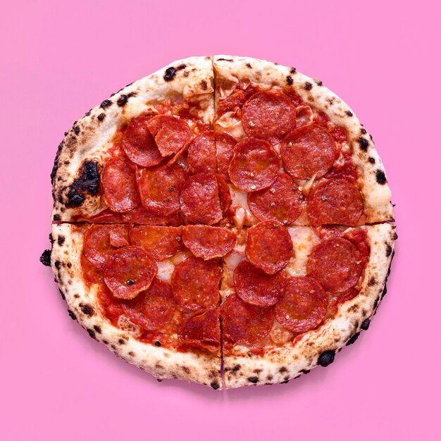 Top view pizza on pink background