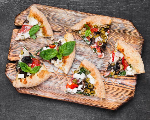 Top view pizza slices on cutting board