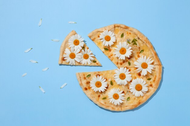 Top view pizza with flowers on blue background