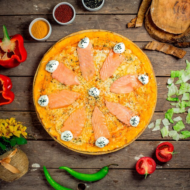 Top view of pizza with salmon and philadelphia cheese