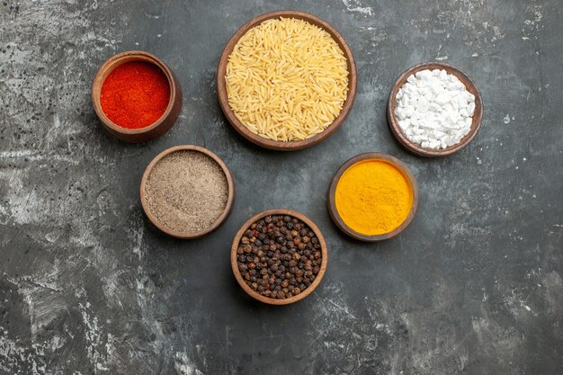 Top view of plain boiled rice with different spices