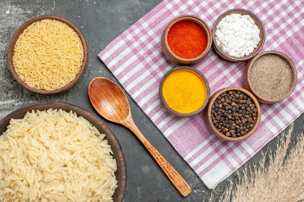 Top view of plain boiled rice with different spices