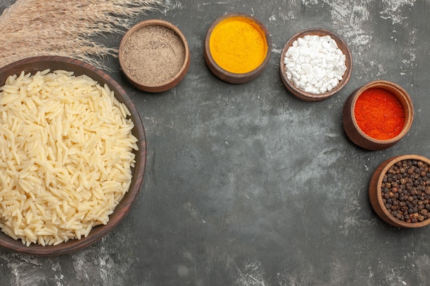 Top view of plain boiled rice with different spices