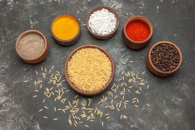 Top view of plain boiled rice with different spices