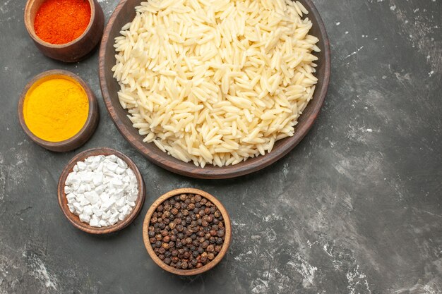 Top view of plain boiled rice with different spices