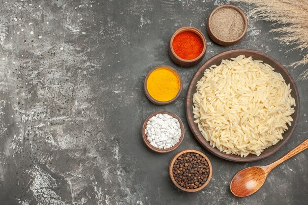 Top view of plain boiled rice with different spices