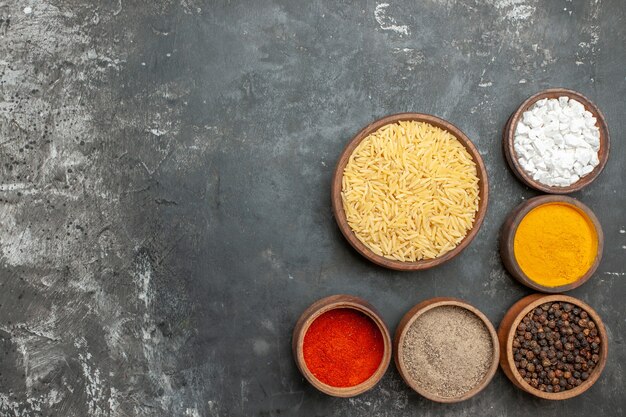 Top view of plain boiled rice with different spices