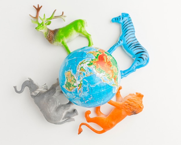 Top view of planet earth with animal figurines for animal day