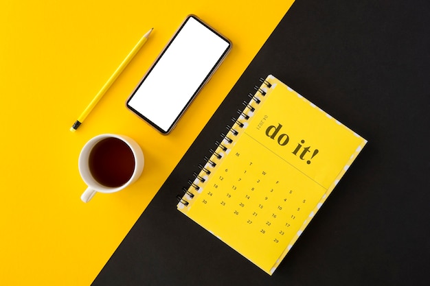 Top view planner yellow calendar and coffee