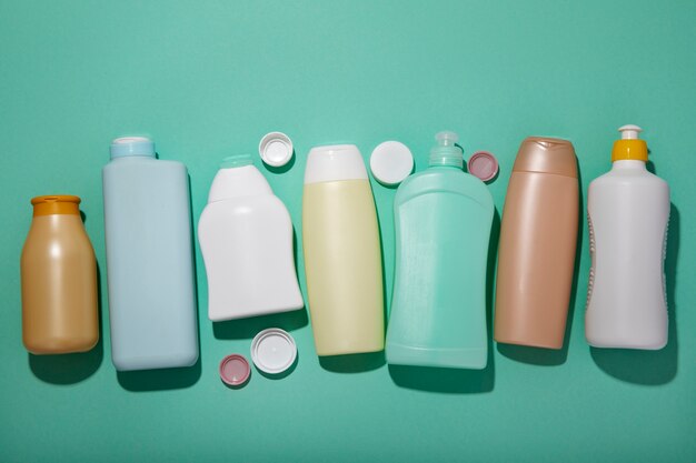 Top view plastic bottles on green background