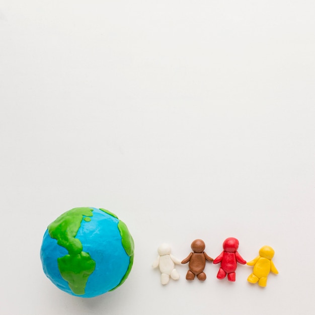 Top view of plasticine globe and people with copy space