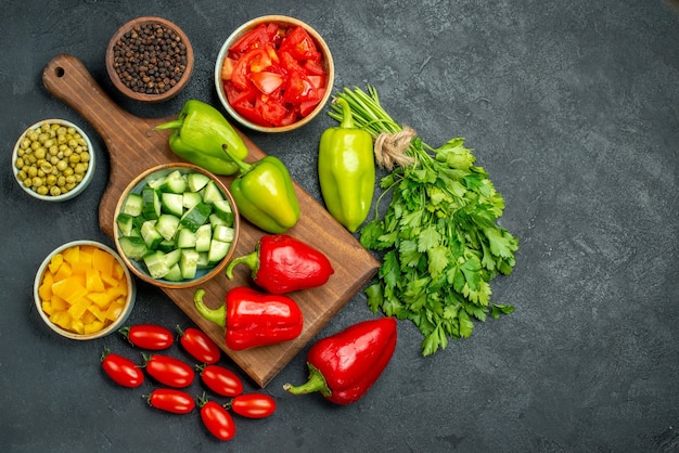 Top view of plate stand with vegetables over and near to it and with free place for text on dark greyish background