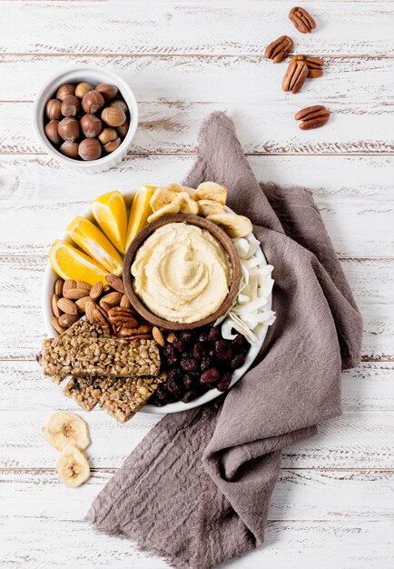 Top view of plate with assortment of nuts and cereal bars