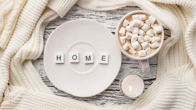 Top view of plate with cup of hot cocoa with marshmallows