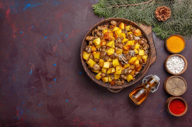 튀긴 버섯과 감자 다채로운 향신료와 기름이 콘이 있는 가지 옆에 있는 음식 접시가 있는 탑 뷰 플레이트
