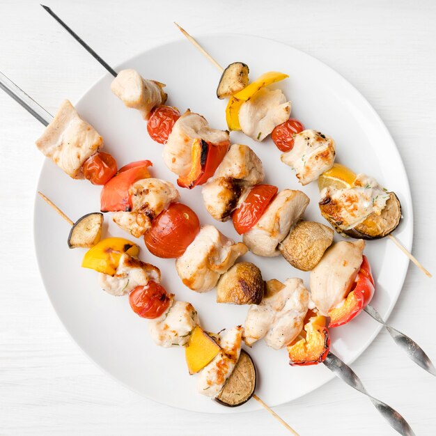 Top view plate with grilled chicken skewers