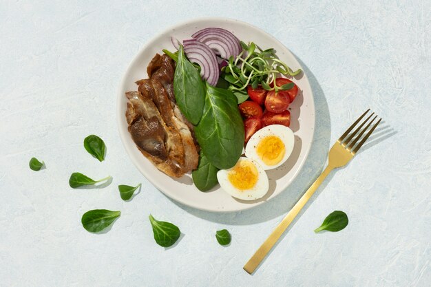 Top view of plate with keto diet food and golden fork