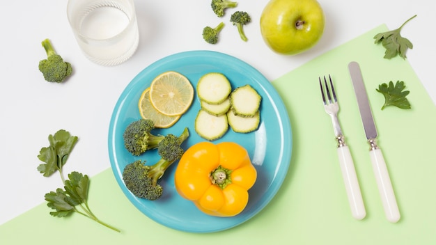 Top view plate with organic vegetables on the table