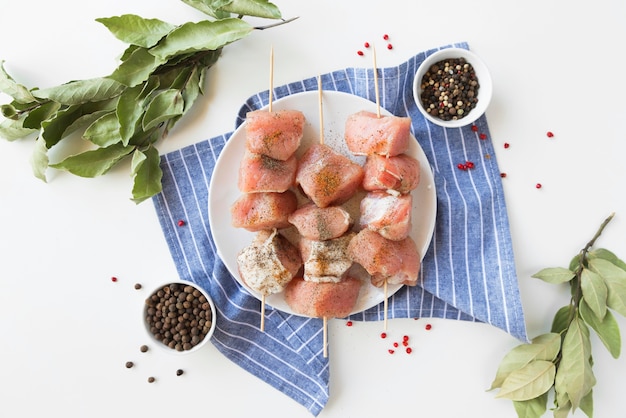 Top view plate with raw meat skewers