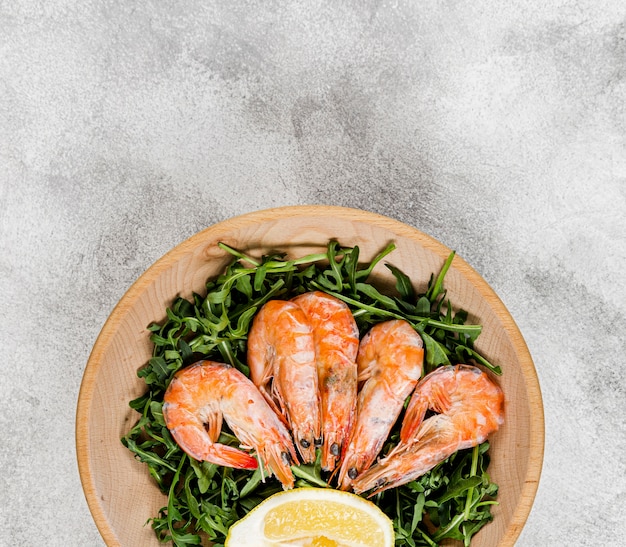 Top view of plate with salad and shrimp