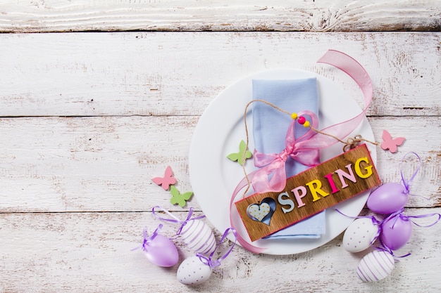 Top view of plate with spring sign and easter eggs