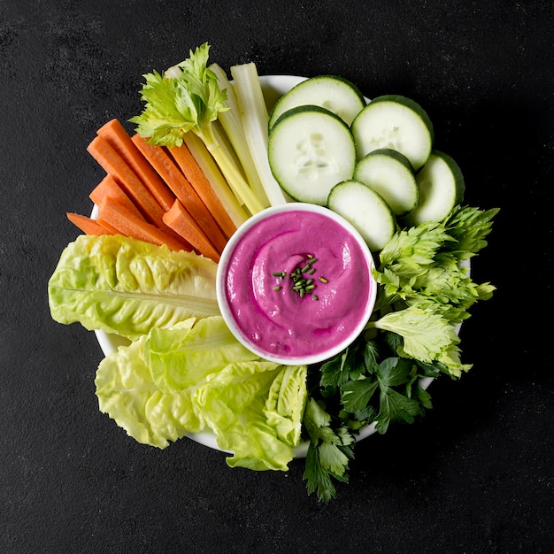 Top view of plate with vegetables and pink sauce