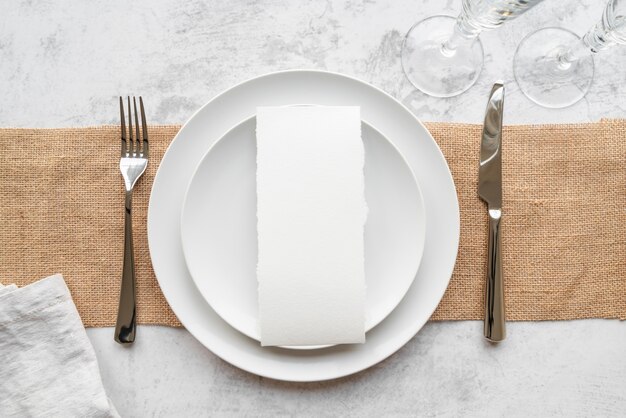 Top view of plates on burlap with cutlery